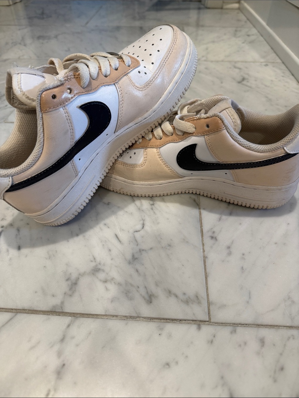 Nike Low-Top Sneakers in White, Beige, and Black Swoosh